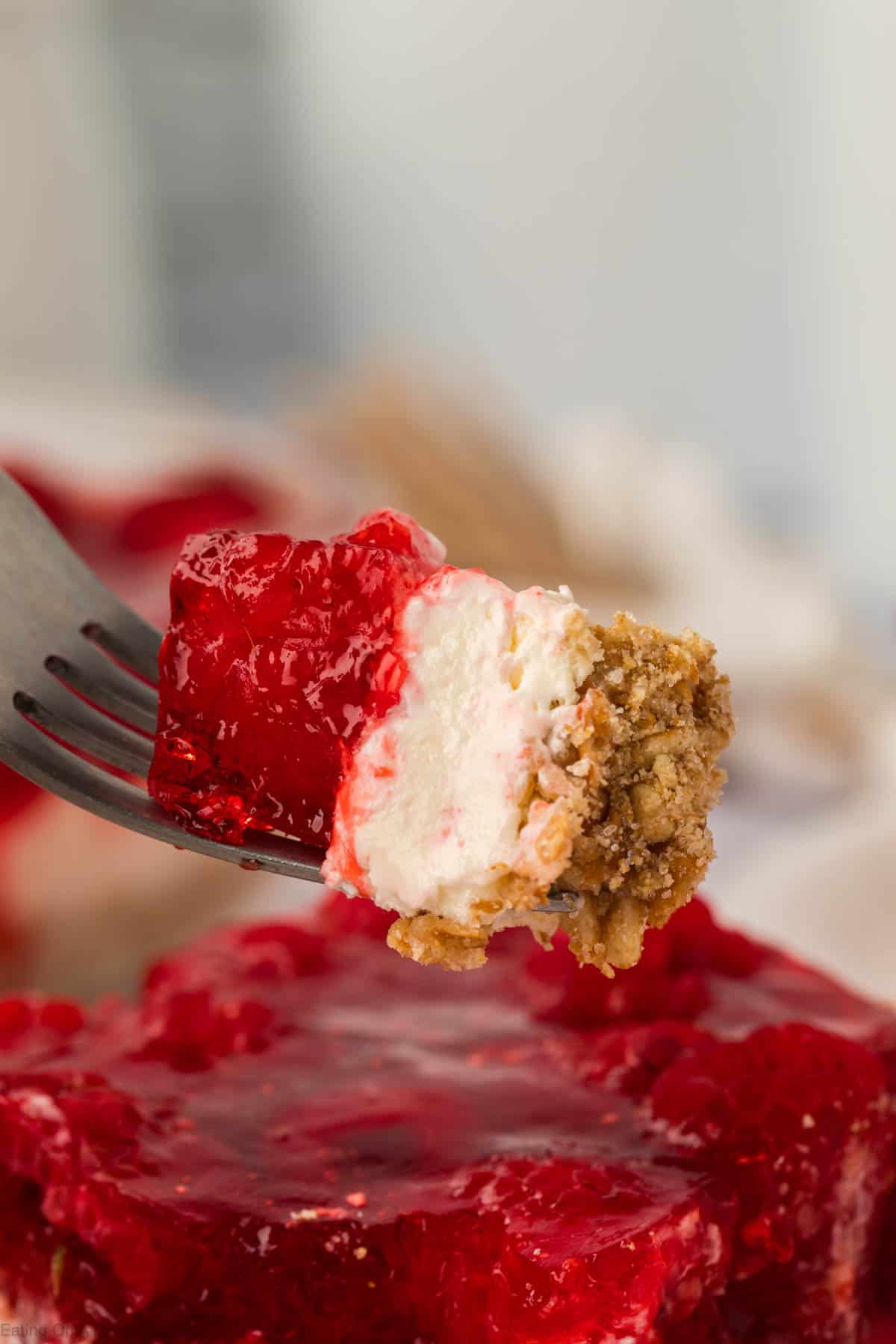 A bite of Raspberry Jello Pretzel Salad on a fork