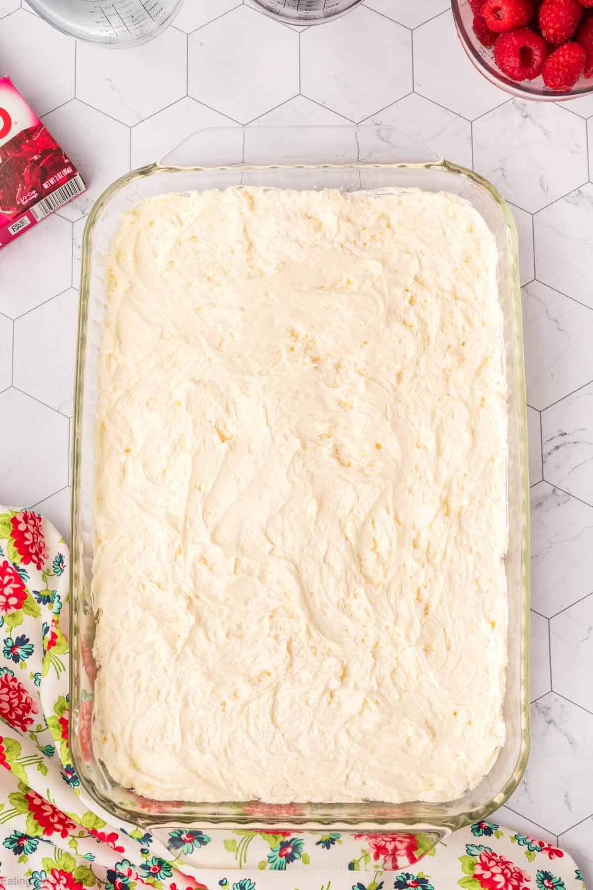 Cream cheese mixture spread in a baking dish 