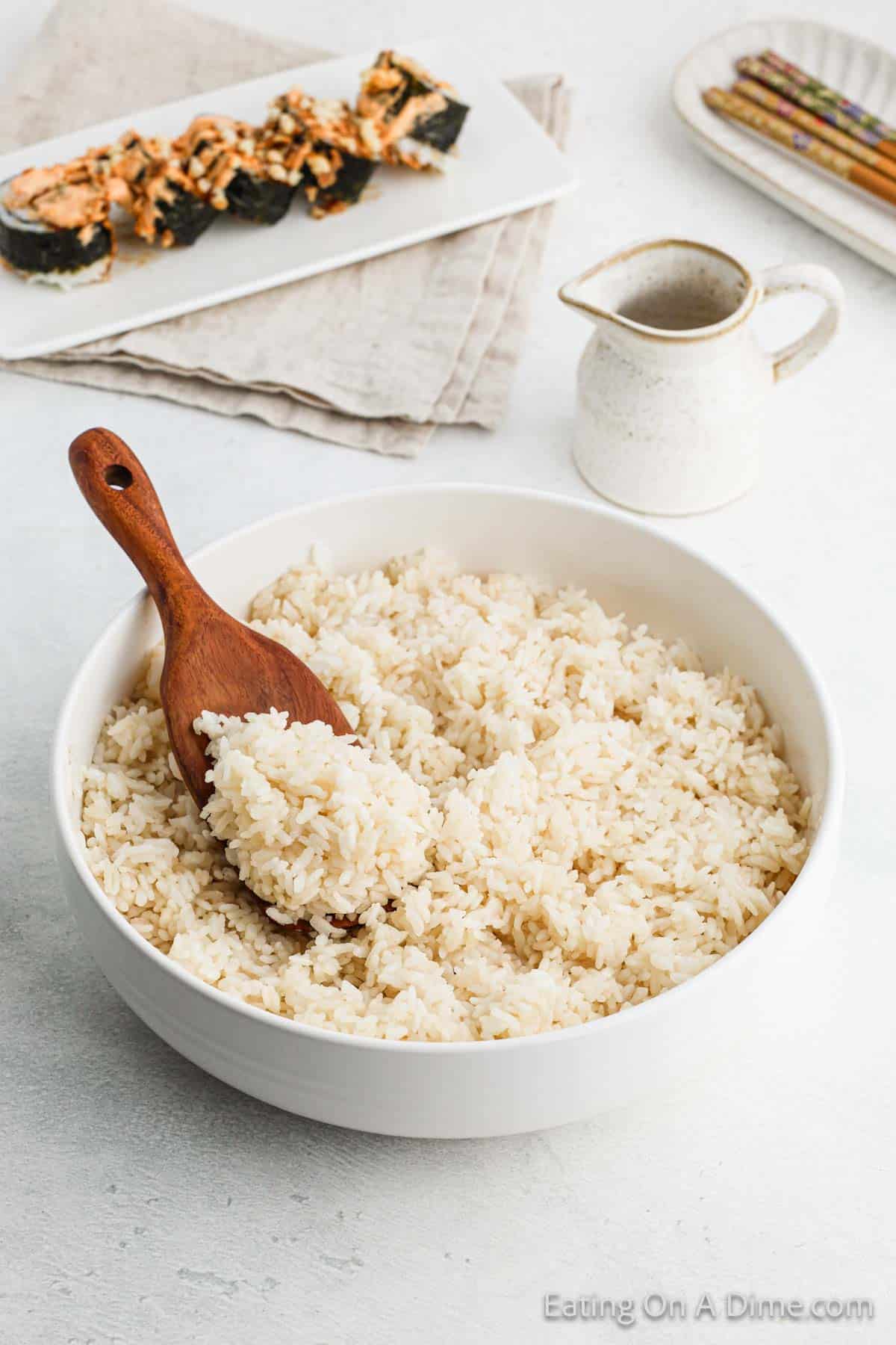 White Rice in a bowl with a wooden spoon