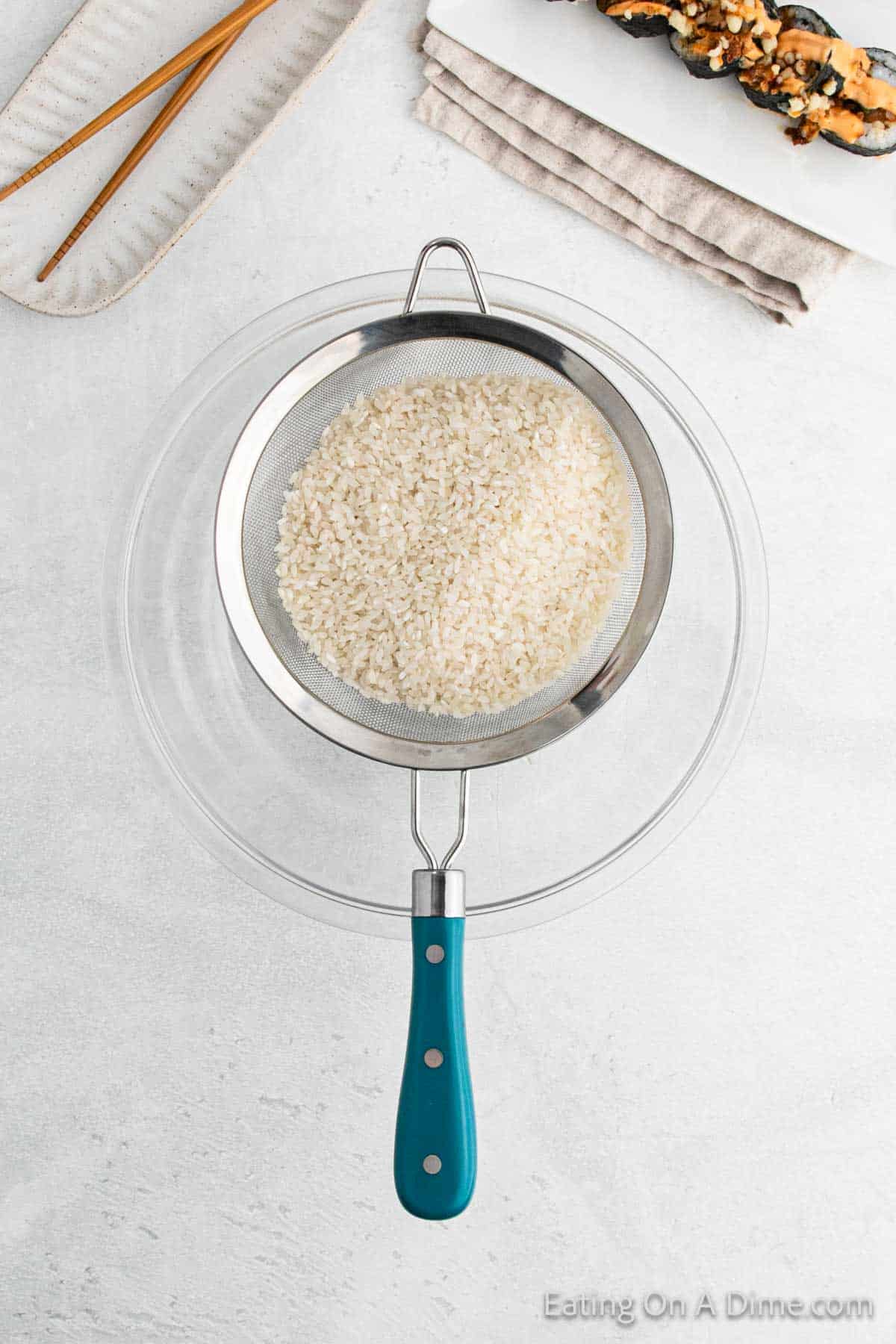 Japanese Rice in a colander over a clear bowl