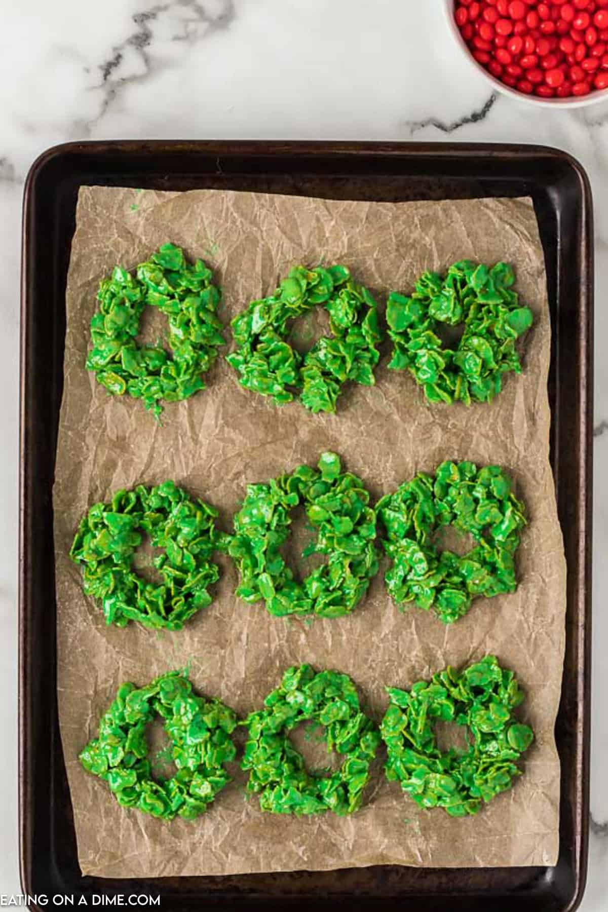 Green Cereal Mixture shaped into a wreath on a baking sheet lined with parchment paper