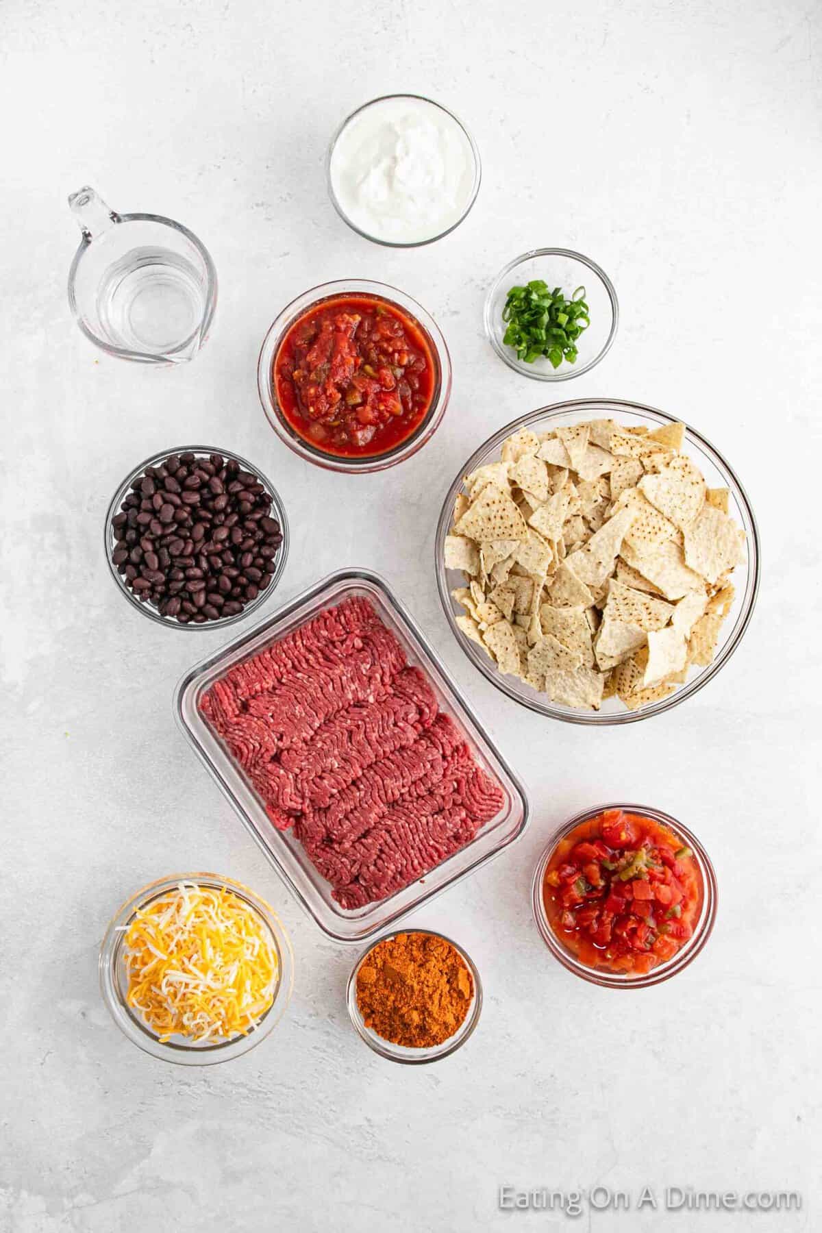 Ingredients - Ground Beef, Taco Seasoning, Water, Black Beans, diced tomatoes, salsa, shredded cheese, tortilla chips, sour cream, green onions