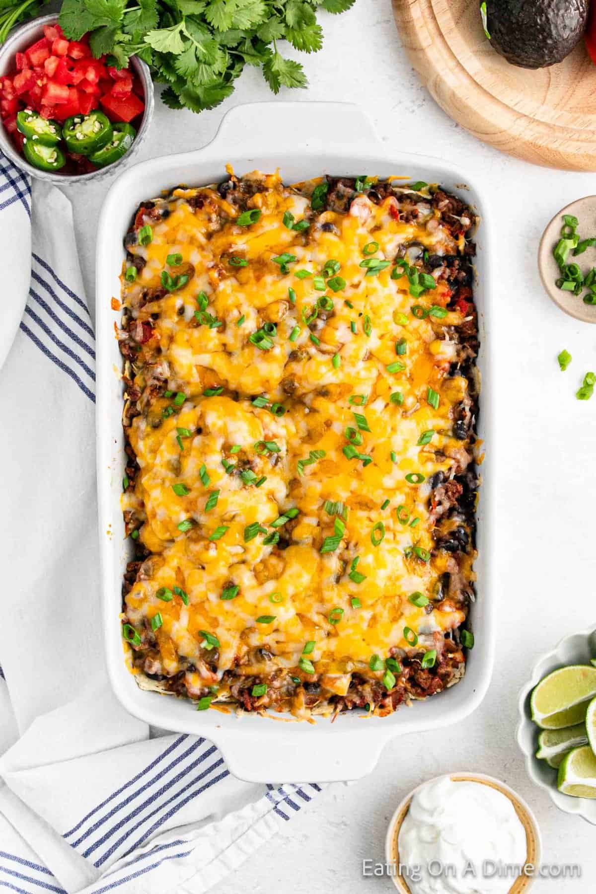 Melted cheese on top of ground beef mixture in a baking dish