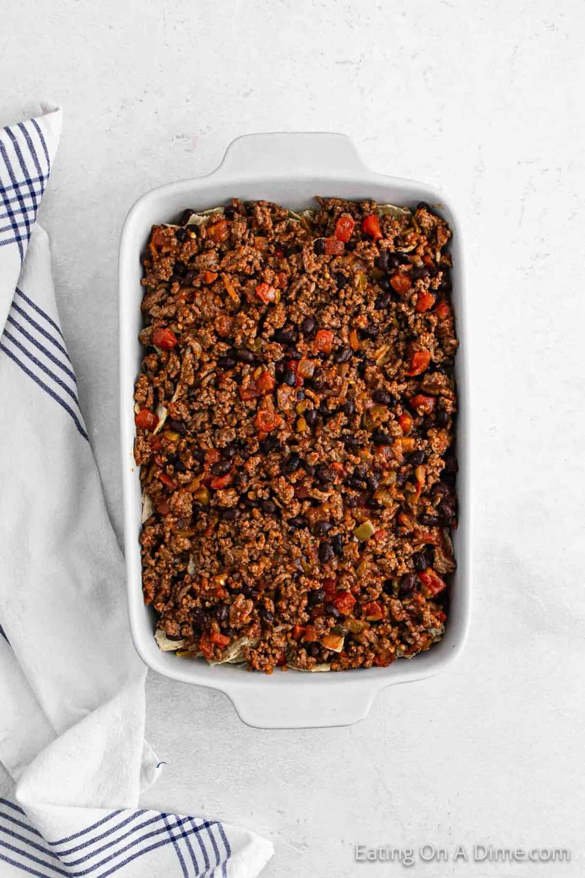 Topping ground beef mixture in a baking dish