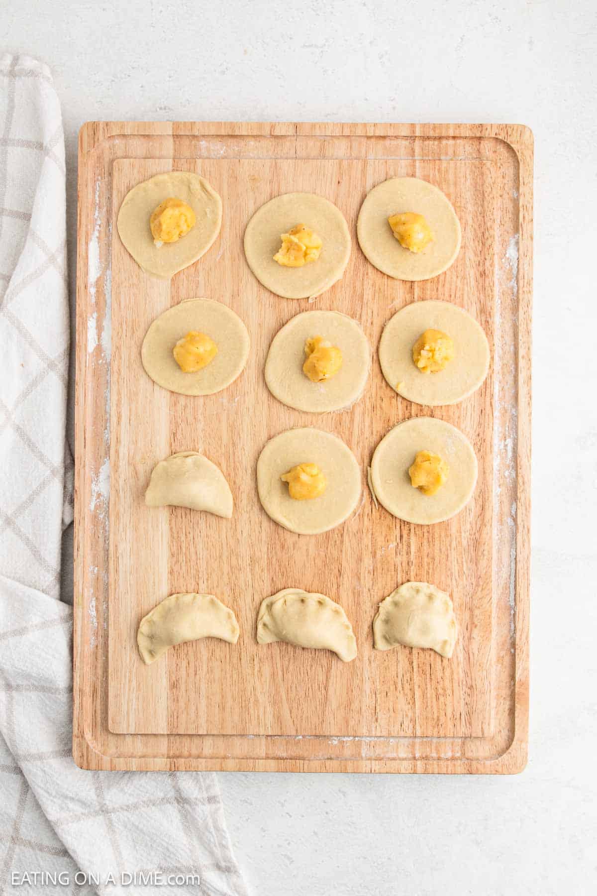 Round dough topped with filling and then closed tightly