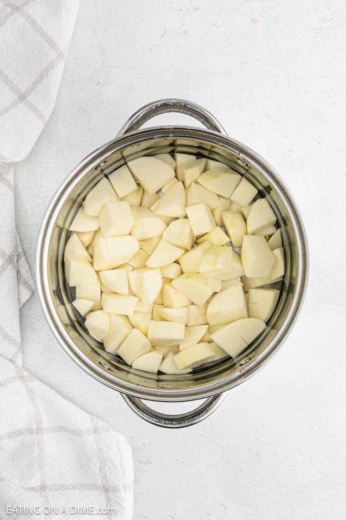 Diced potatoes in a large pot of water