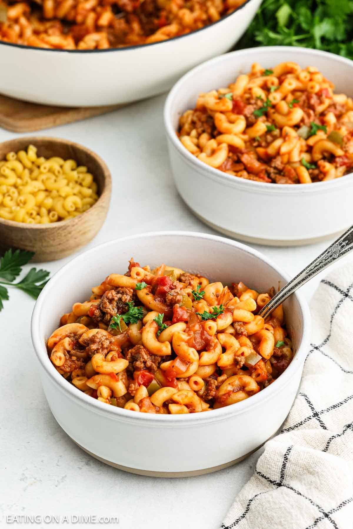 Bowls of Goulash with a small bowl of macaroni noodles on the side