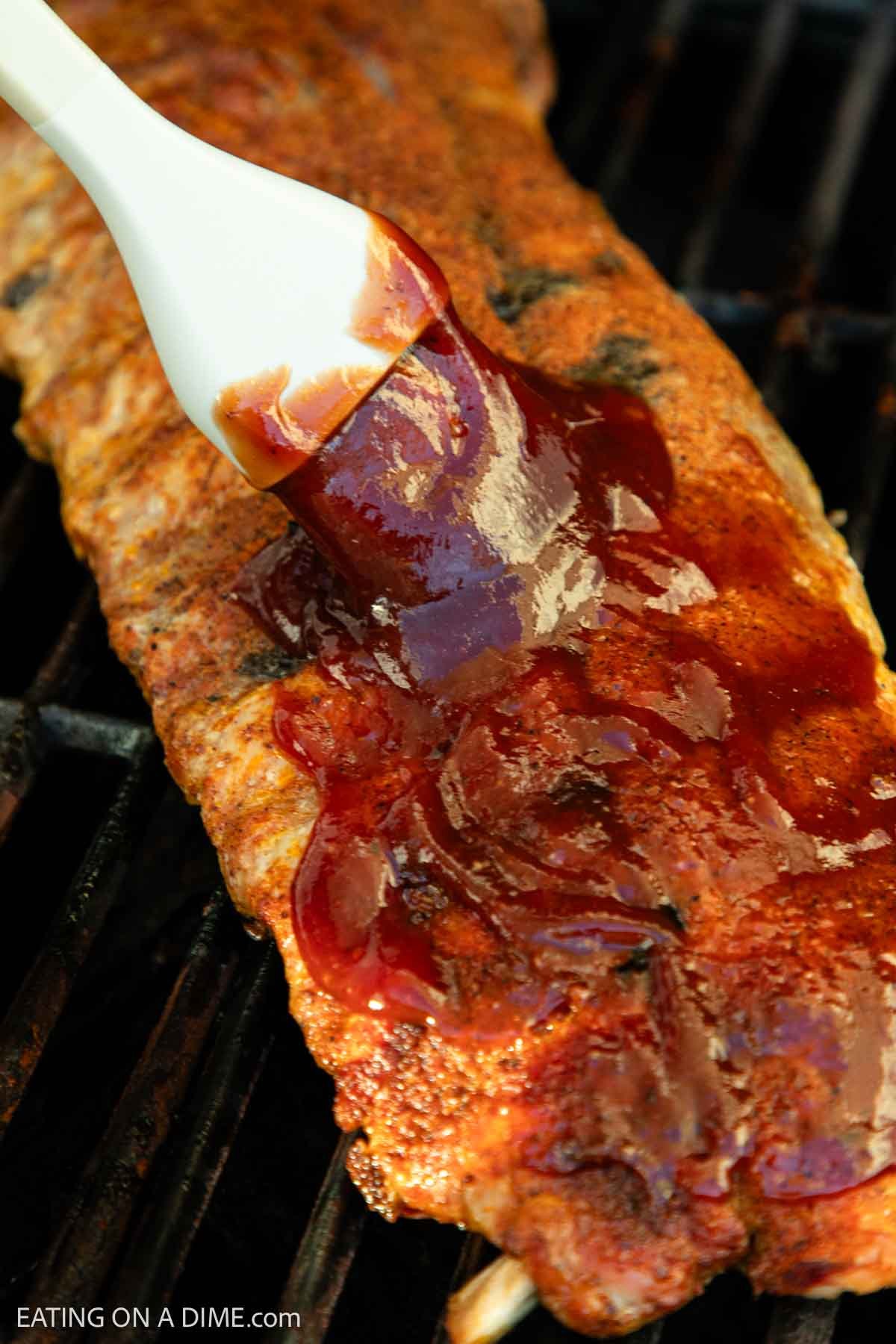 Brushing the ribs with BBQ sauce 