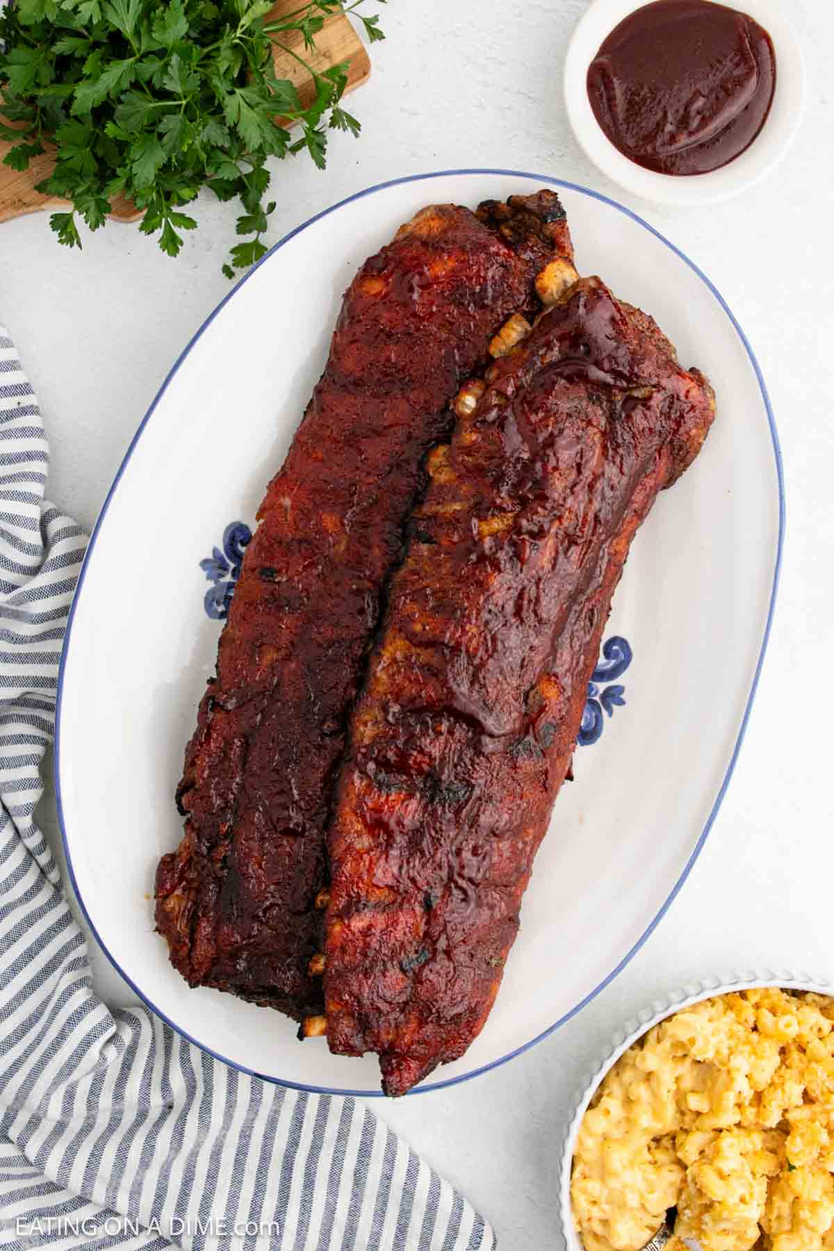 BBQ Baby Back Ribs stacked on a platter