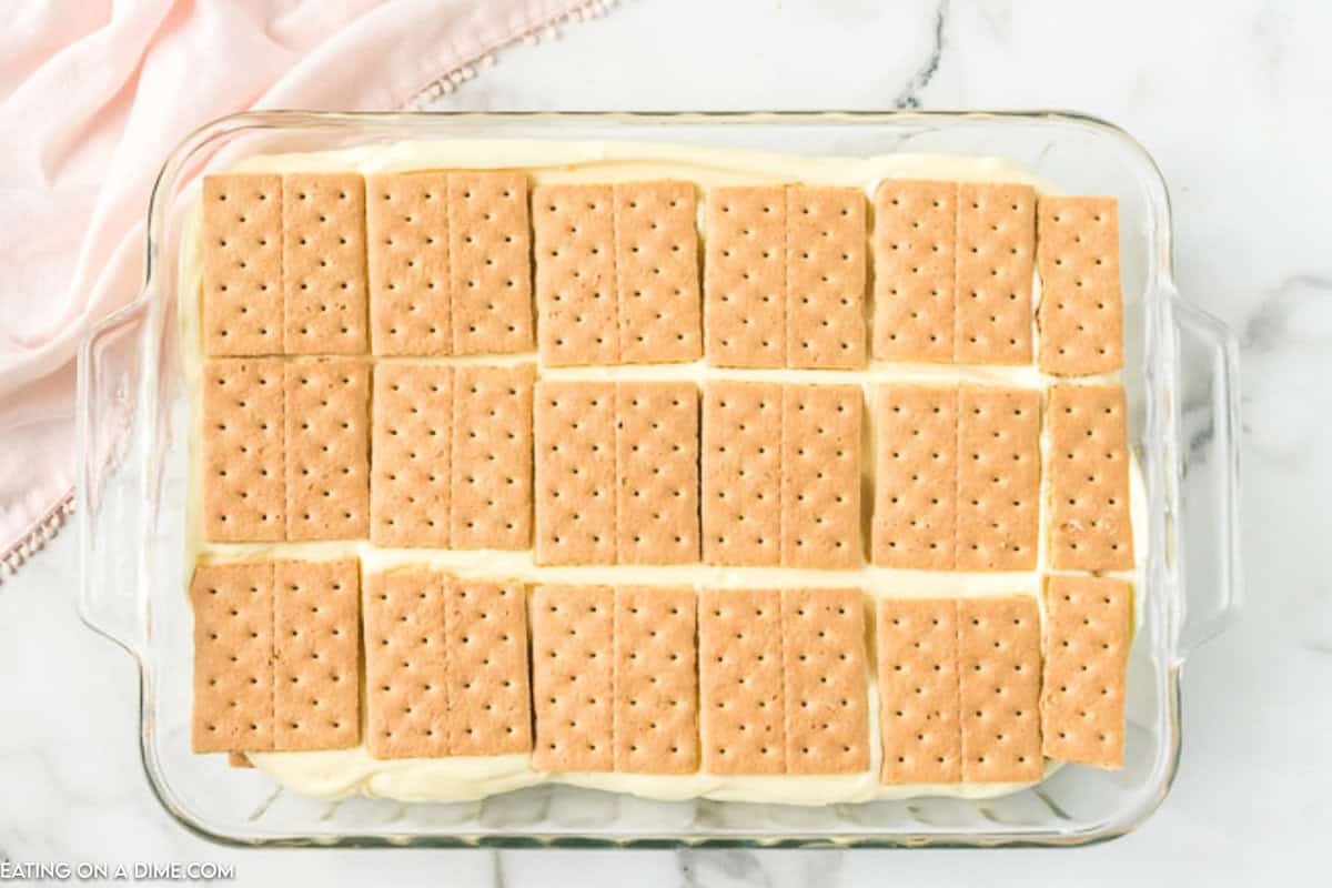 Graham Crackers placed on top of the vanilla pudding mix in the baking pan