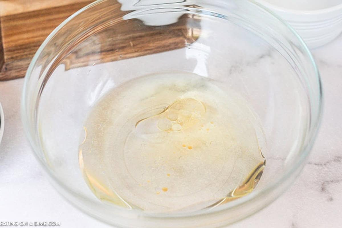 Vanilla, vinegar, oil, and water in a bowl