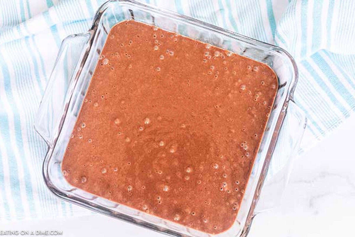 Chocolate Cake batter poured into a glass cake pan